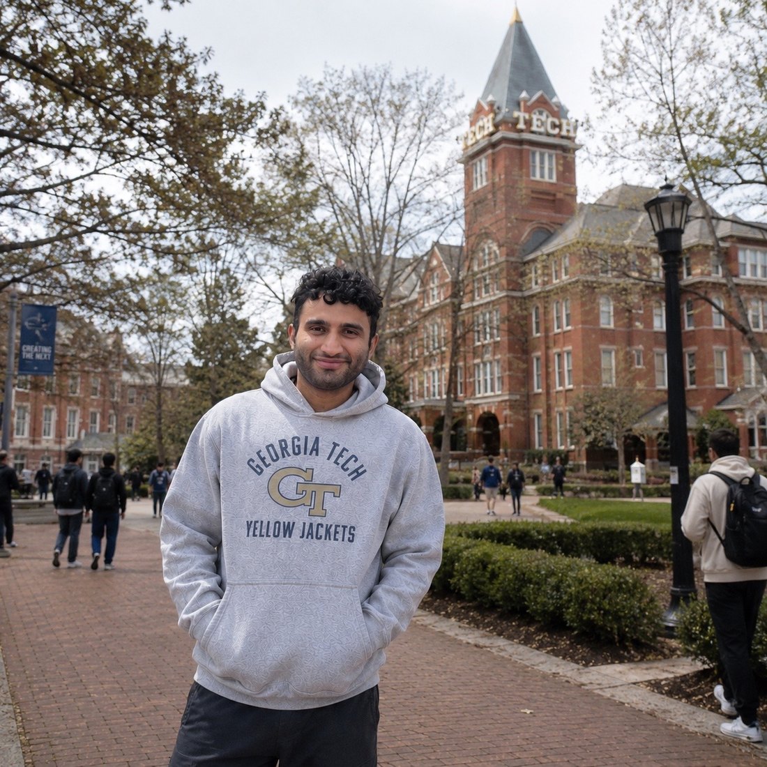 Pranay on the Georgia Tech campus in a grey Georgia Tech hoodie, Tech Tower behind him.
